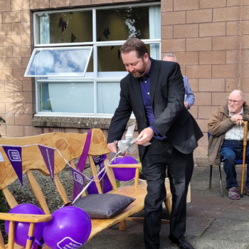 The Commissioner handling balloons at a community event