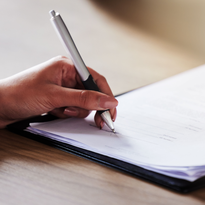 Woman writing on a document